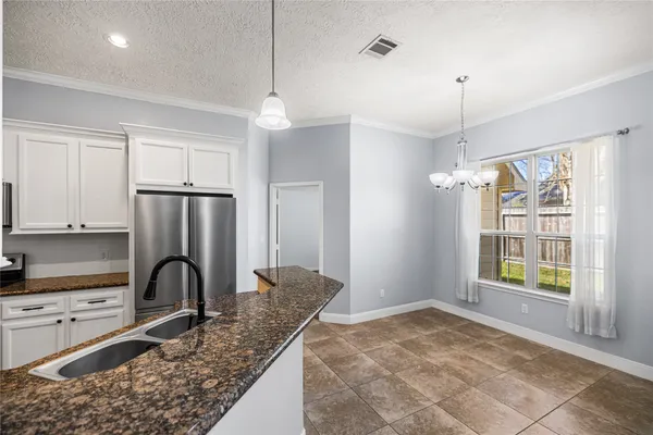 a view of an empty room with a fireplace and a window