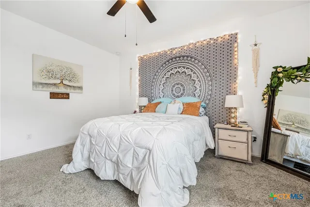 a bedroom with bed and painting on the wall