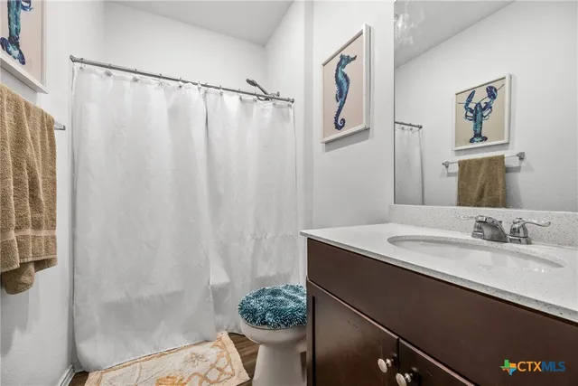 a bathroom with a sink a toilet and a mirror