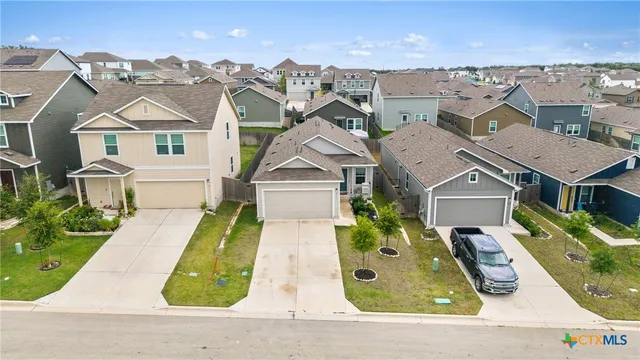 aerial view of a house with a yard