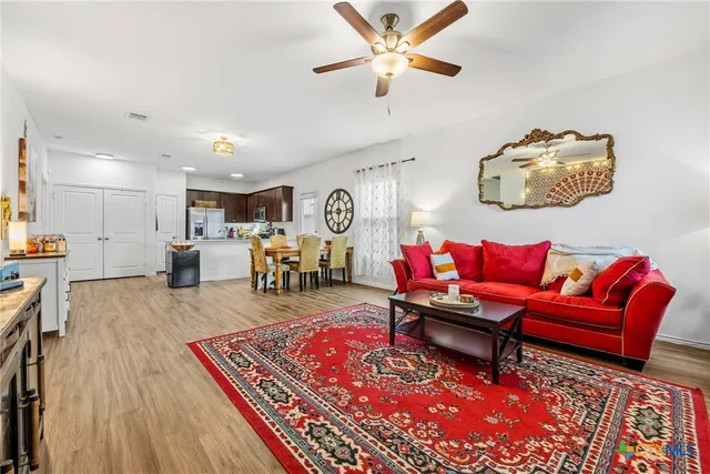 a living room with furniture and wooden floor