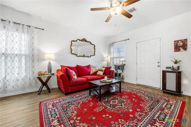 a living room with furniture and a rug