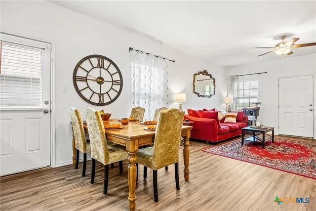 a living room with furniture a rug and wooden floor