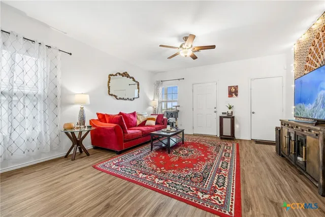 a living room with furniture and a flat screen tv