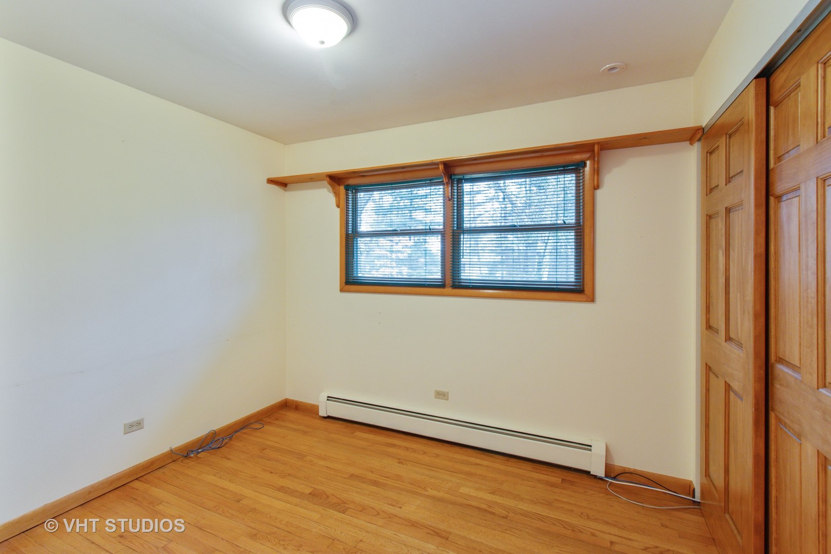 708 Hickory Road Woodstock, IL 60098 - Photo 13 of 22 a view of an empty room with wooden floor and a window