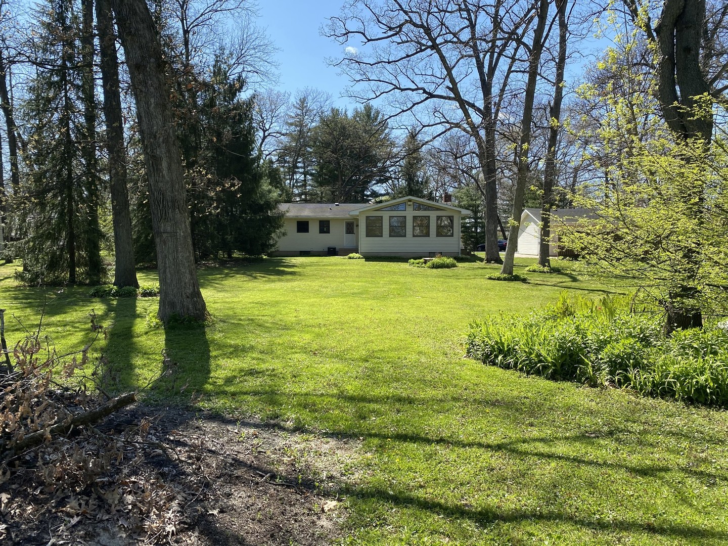708 Hickory Road Woodstock, IL 60098 - Photo 19 of 22 a view of a garden with large trees