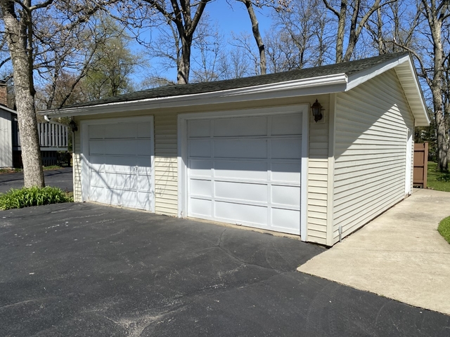 708 Hickory Road Woodstock, IL 60098 - Photo 3 of 22 a view of backyard and garage