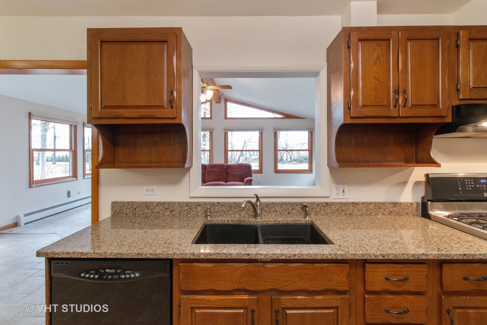 708 Hickory Road Woodstock, IL 60098 - Photo 8 of 22 a kitchen with granite countertop a sink a stove and cabinets