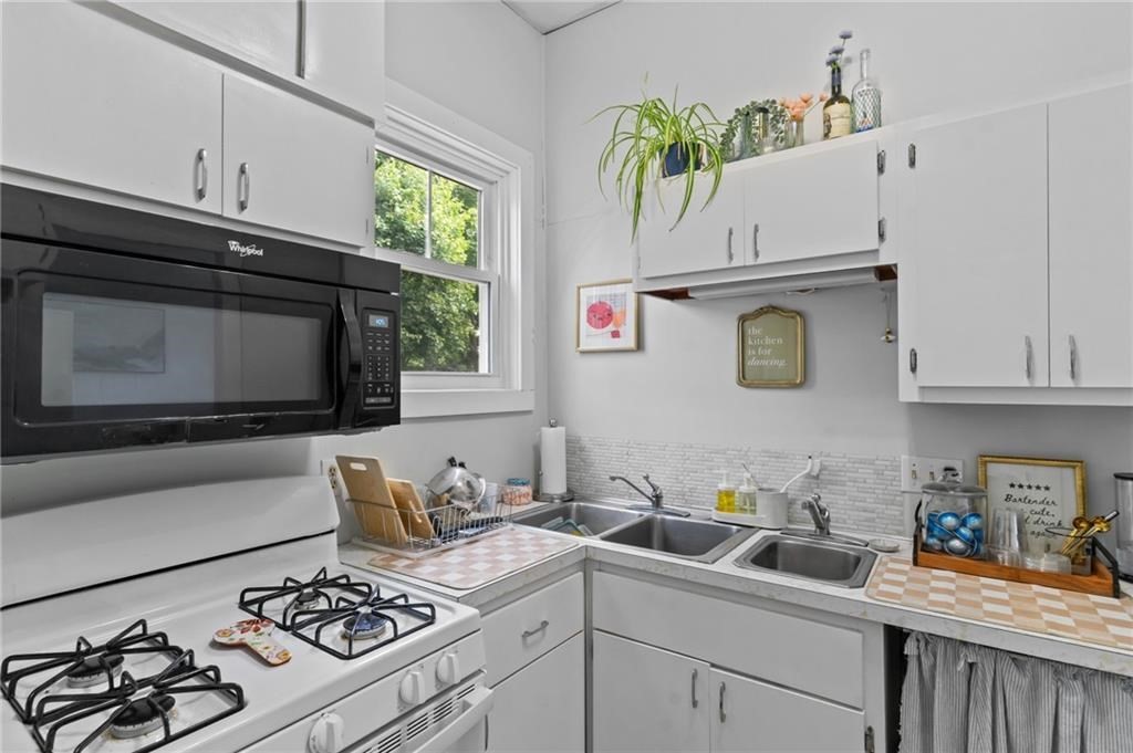 21 Federal Street Warren, RI 02885 - Photo 11 of 27 a kitchen with stainless steel appliances a stove a sink and a microwave