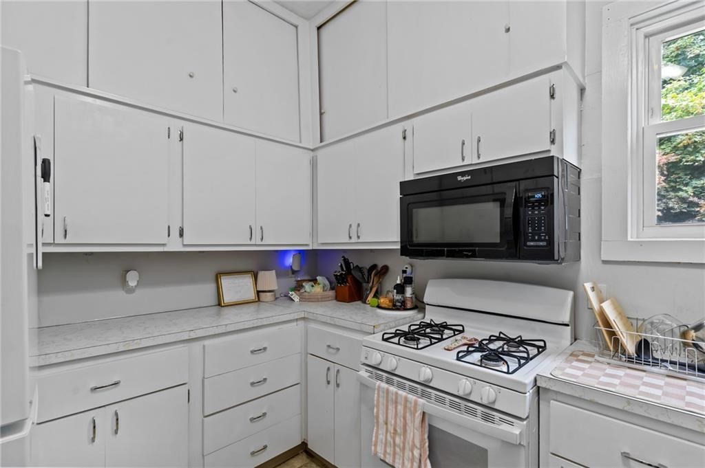 21 Federal Street Warren, RI 02885 - Photo 12 of 27 a kitchen with stainless steel appliances a stove and a microwave