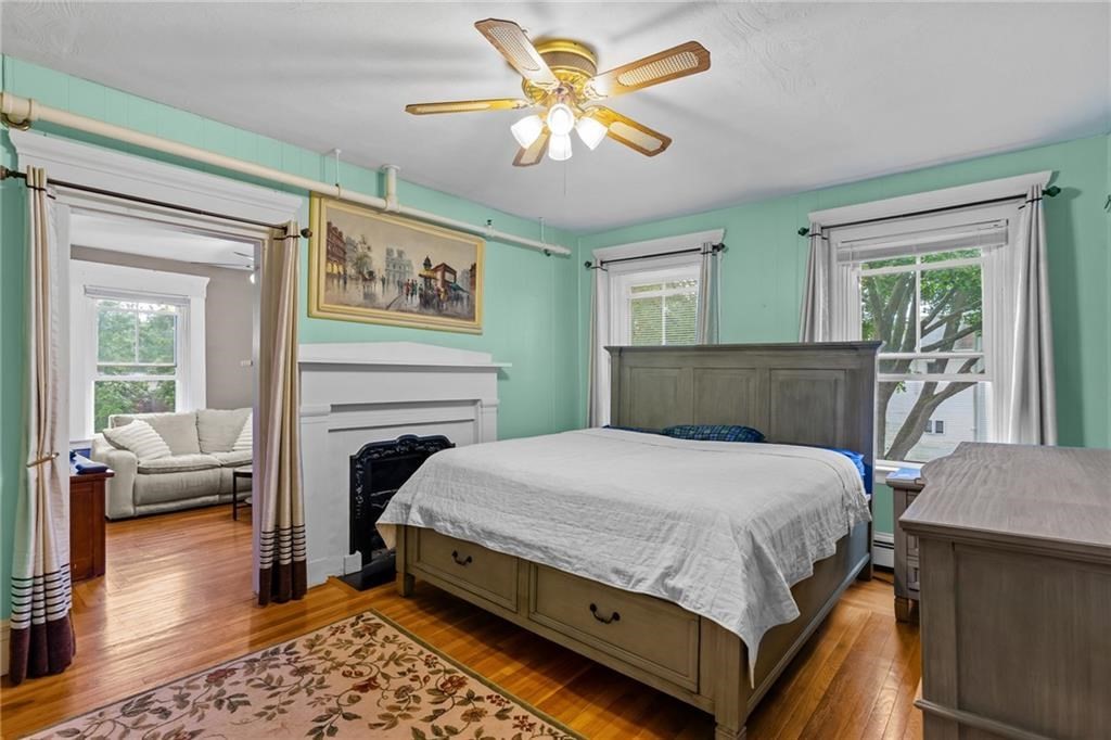 21 Federal Street Warren, RI 02885 - Photo 15 of 27 a bedroom with a bed and a chandelier