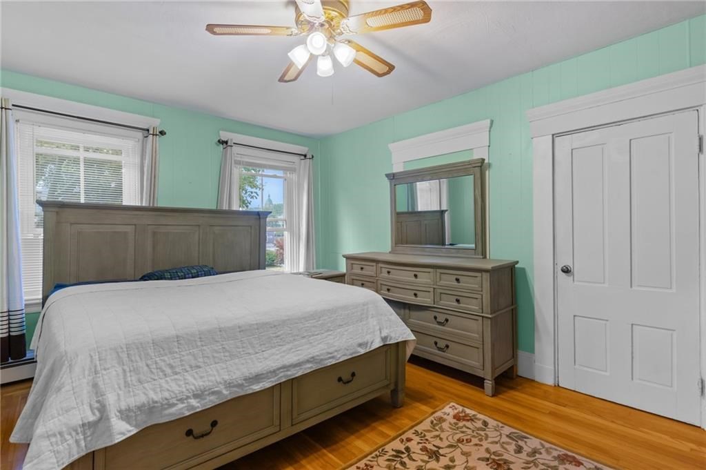21 Federal Street Warren, RI 02885 - Photo 16 of 27 a bedroom with a bed and a chandelier