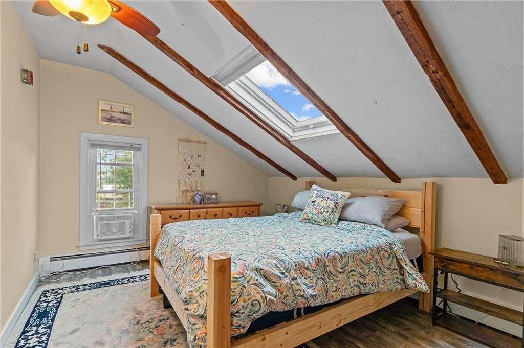 21 Federal Street Warren, RI 02885 - Photo 21 of 27 a bedroom with a bed next to a window