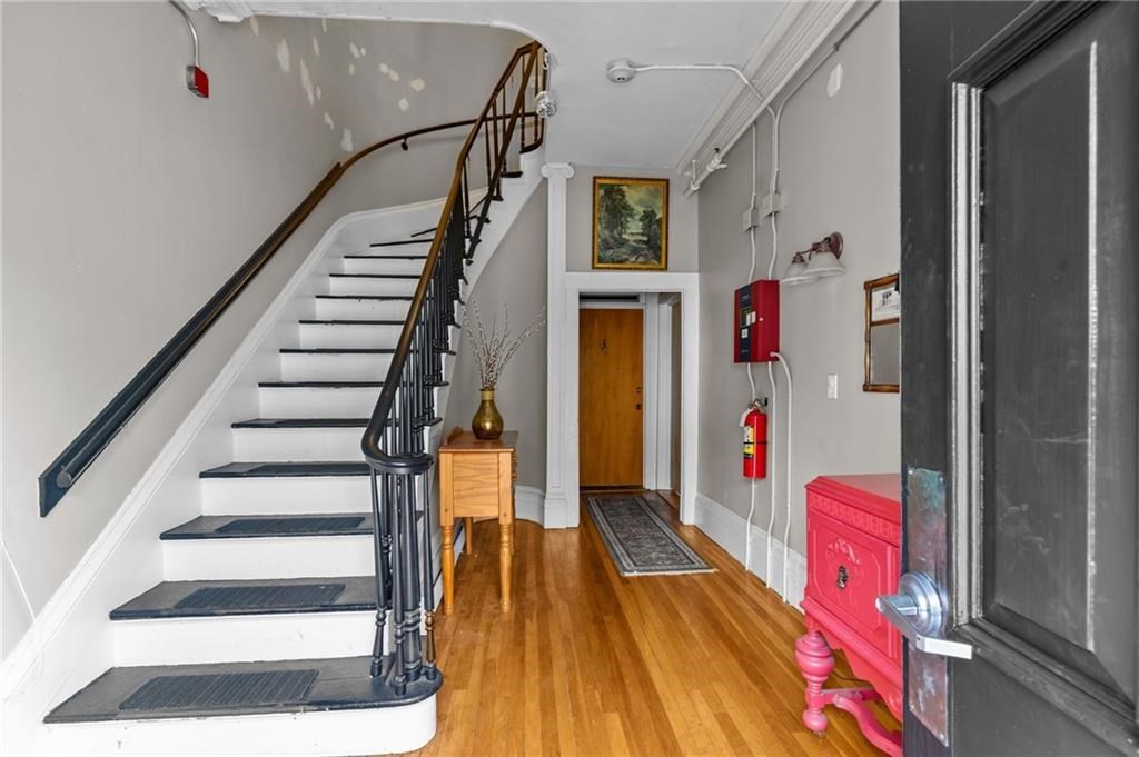 21 Federal Street Warren, RI 02885 - Photo 3 of 27 a view of entryway and hall with wooden floor