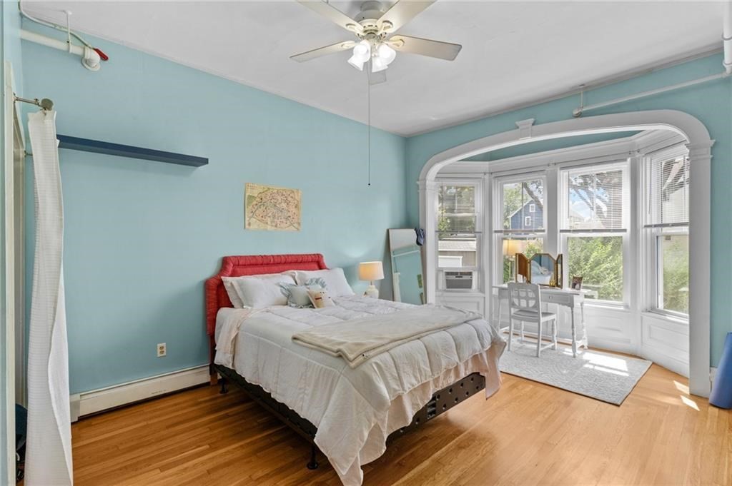 21 Federal Street Warren, RI 02885 - Photo 4 of 27 a bedroom with a bed and a large window