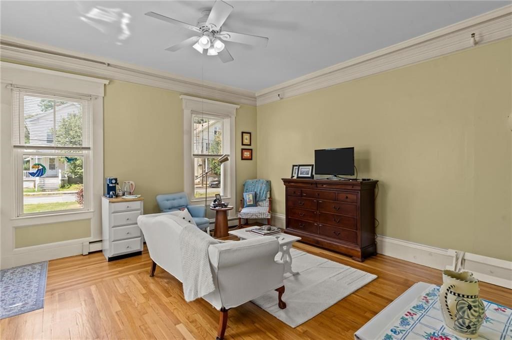 21 Federal Street Warren, RI 02885 - Photo 6 of 27 a living room with a couch and a window with wooden floor