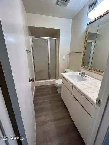 a bathroom with a sink a mirror and a toilet