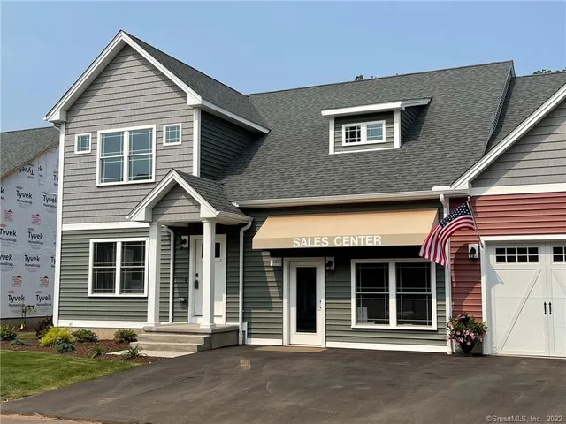 a view of a house with a garage and large windows