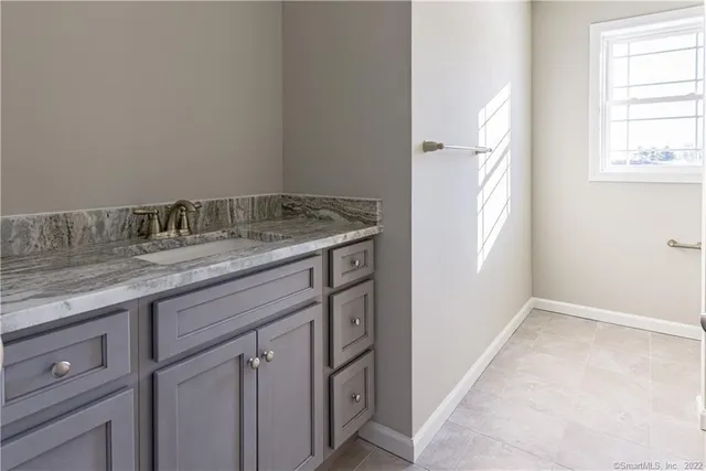a utility room with granite countertop cabinets washer and dryer