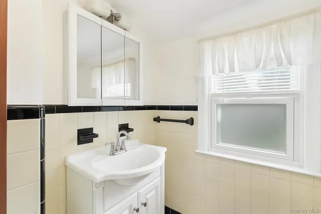 a bathroom with a sink a mirror and a shower