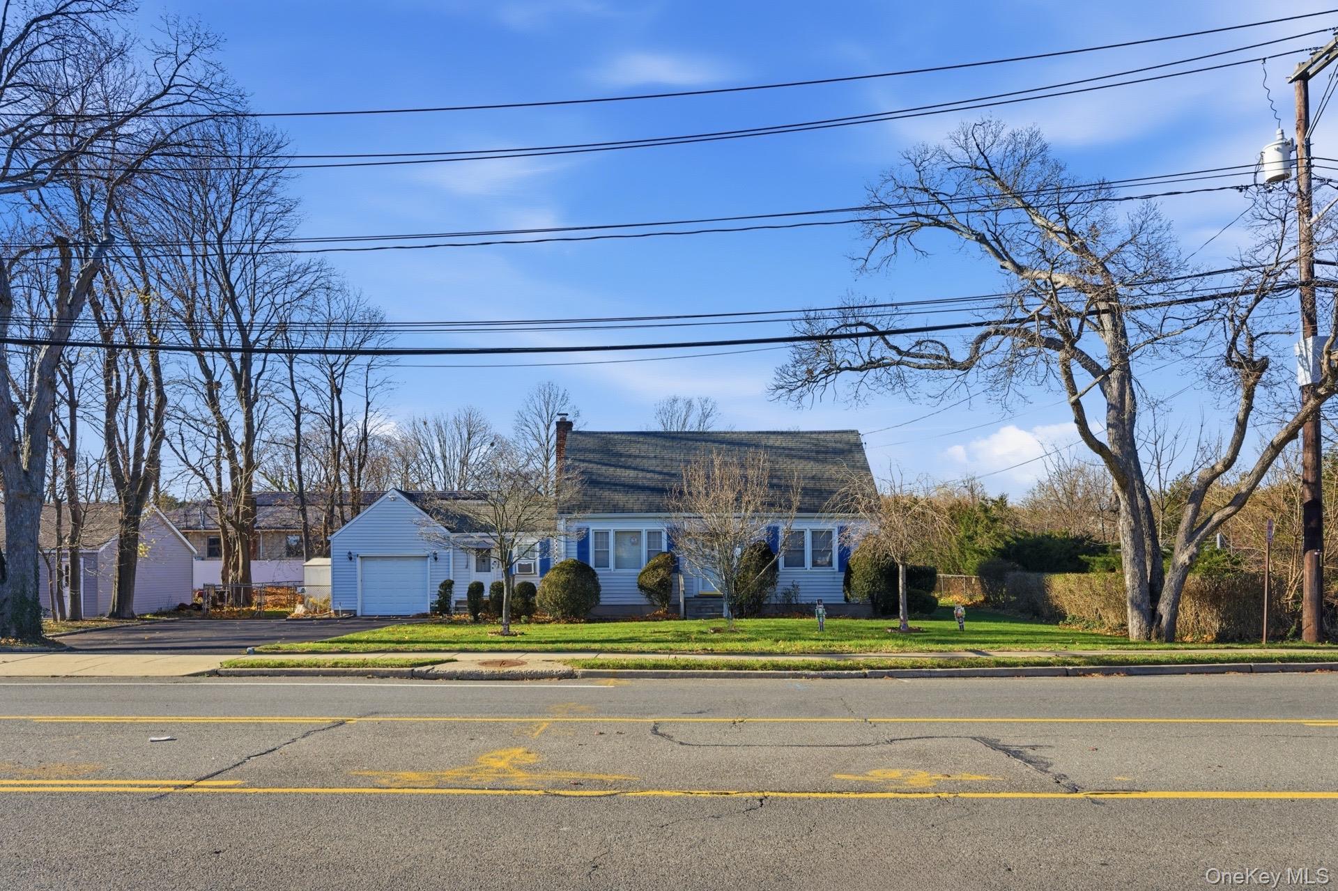 1547 Walt Whitman Road Melville, NY 11747 - Photo 3 of 25 a view of a building with a cars on the road