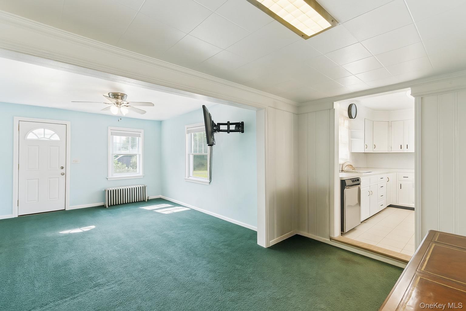1547 Walt Whitman Road Melville, NY 11747 - Photo 4 of 25 a view of an empty room with window and cabinet