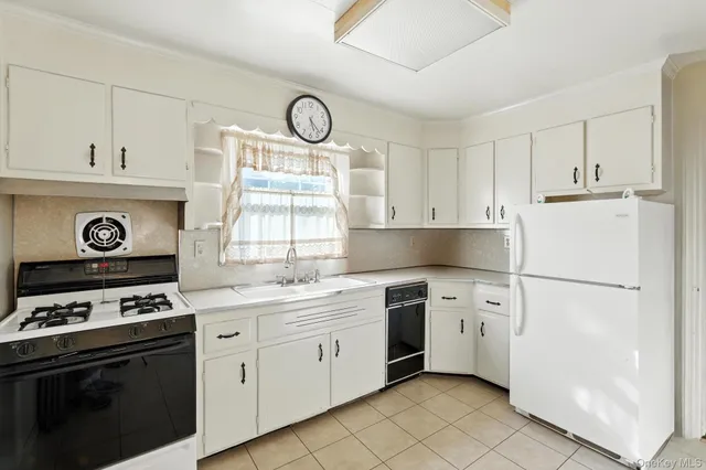 a kitchen with stainless steel appliances a stove a sink and a refrigerator