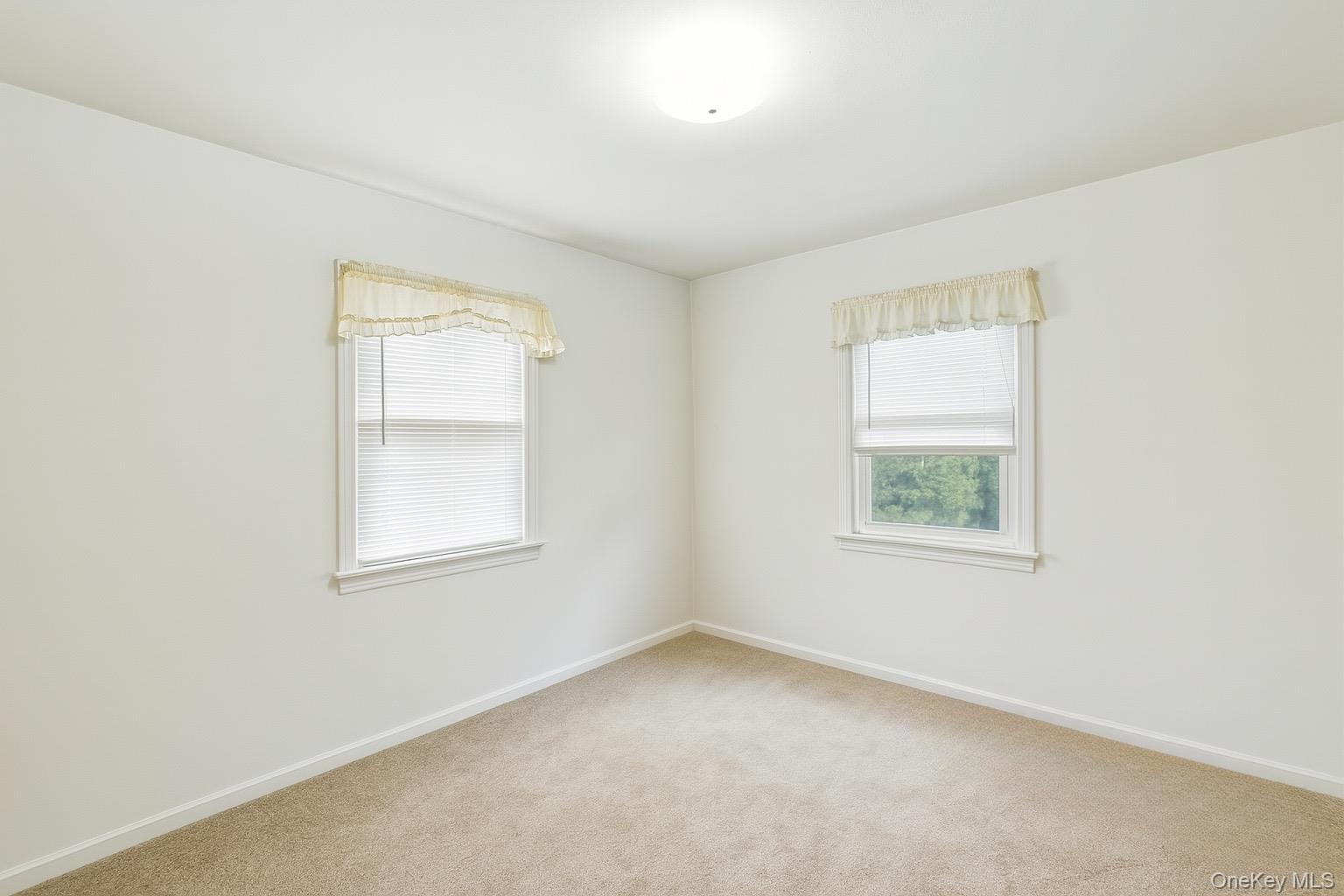 1547 Walt Whitman Road Melville, NY 11747 - Photo 8 of 25 an empty room with windows