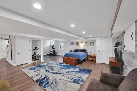 a bedroom with furniture and a wooden floor