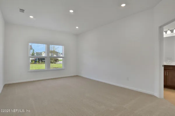a view of an empty room and wooden floor