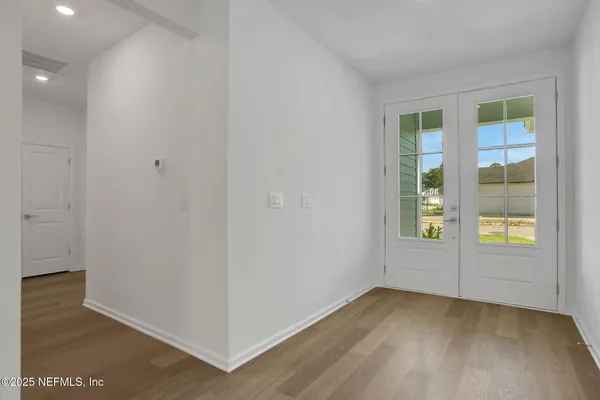 a view of a big room with closet and windows