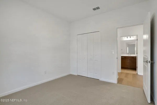 a view of an empty room and a window