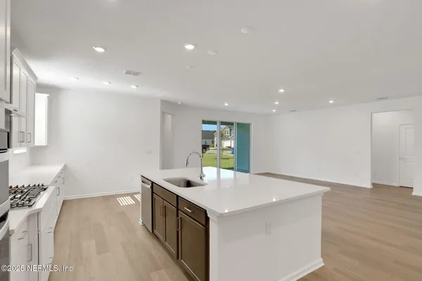 a kitchen with granite countertop white cabinets stainless steel appliances and sink