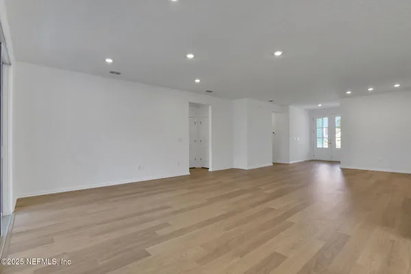 a view of kitchen with kitchen island sink and refrigerator