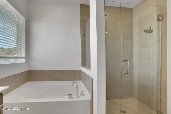 a bathroom with a bathtub and a sink