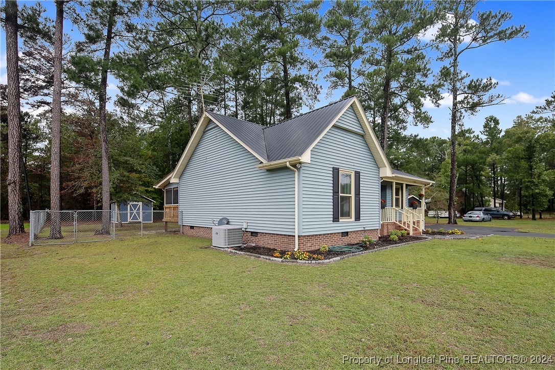 150 Cypress Road Cameron, NC 28326 - Photo 3 of 50 a view of a house with a yard and sitting area