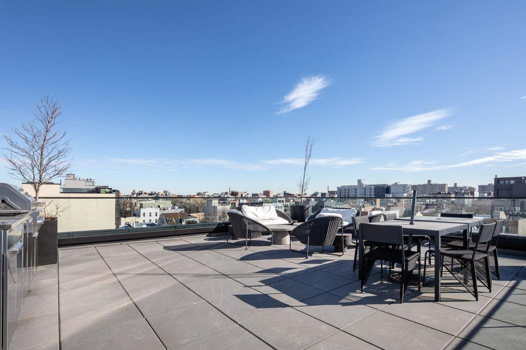 550 Metropolitan Avenue, Unit PHA Brooklyn, NY 11211 - Photo 10 of 11 a terrace with outdoor seating and city view