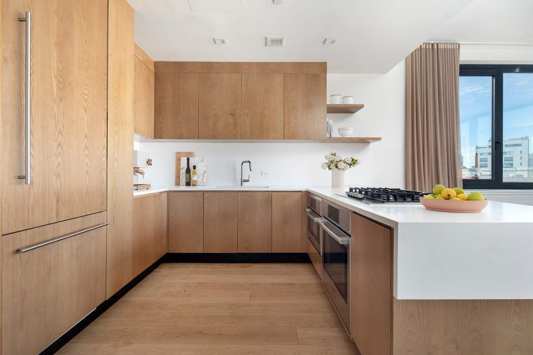 550 Metropolitan Avenue, Unit PHA Brooklyn, NY 11211 - Photo 2 of 11 a kitchen with a sink cabinets and appliances