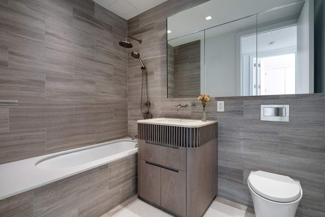 550 Metropolitan Avenue, Unit PHA Brooklyn, NY 11211 - Photo 6 of 11 a bathroom with a sink a toilet and bathtub