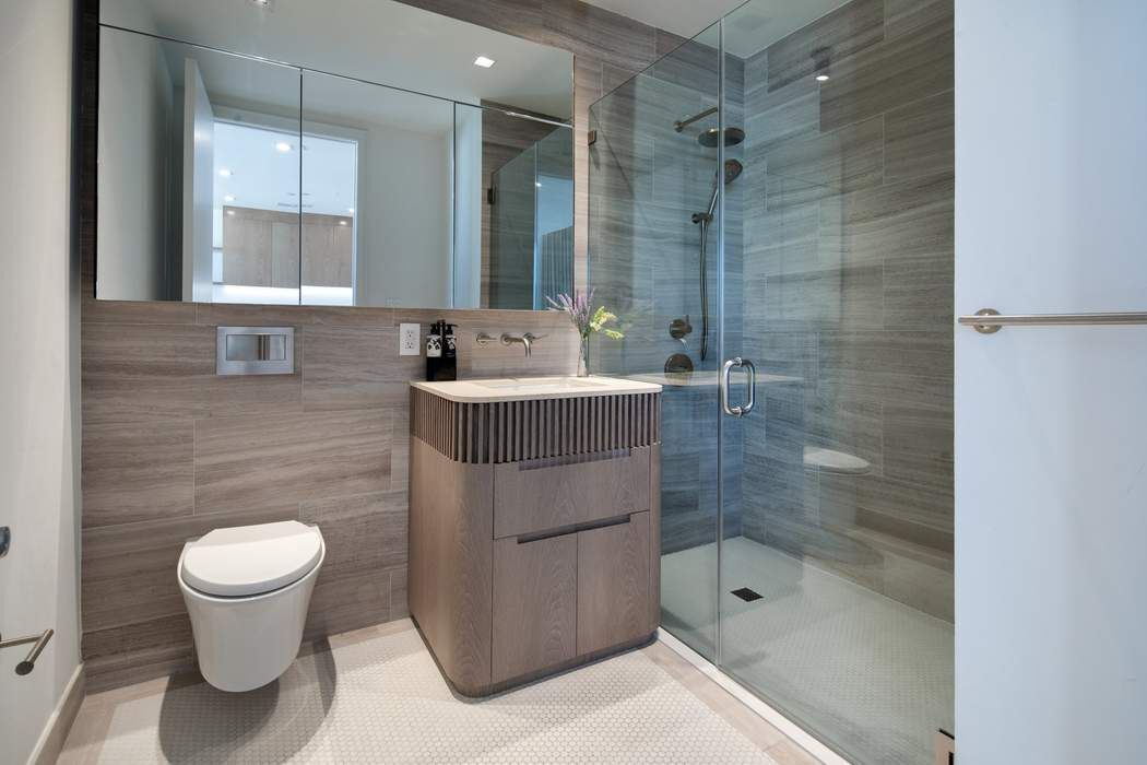 550 Metropolitan Avenue, Unit PHA Brooklyn, NY 11211 - Photo 8 of 11 a bathroom with a shower a toilet and sink