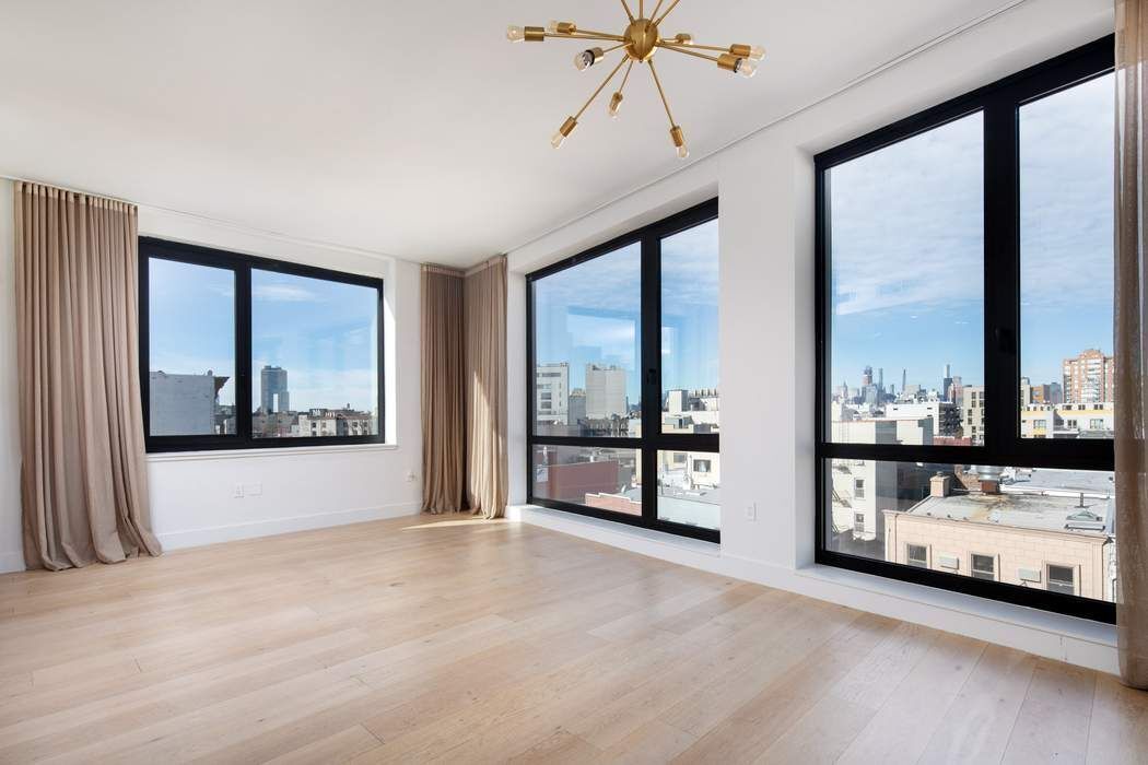 550 Metropolitan Avenue, Unit PHA Brooklyn, NY 11211 - Photo 9 of 11 a view of an empty room with a window