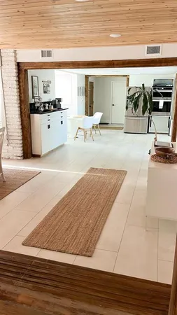 a living room with stainless steel appliances kitchen island granite countertop furniture and a kitchen counter
