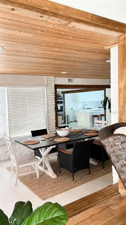 a room with pool table and windows