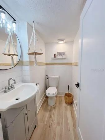 a bathroom with a sink a toilet and a mirror