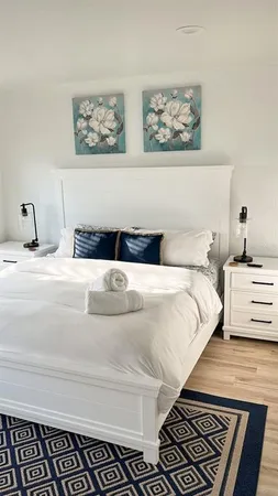 a bedroom with a bed and the view of painting