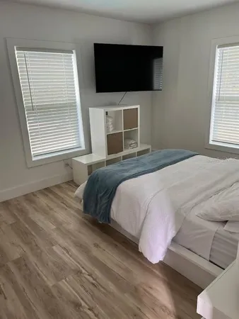 a bedroom with a bed and a flat screen tv
