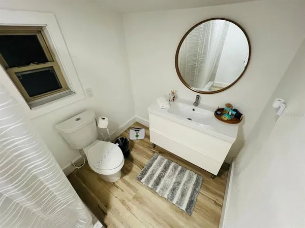 a bathroom with a sink toilet a mirror and tub