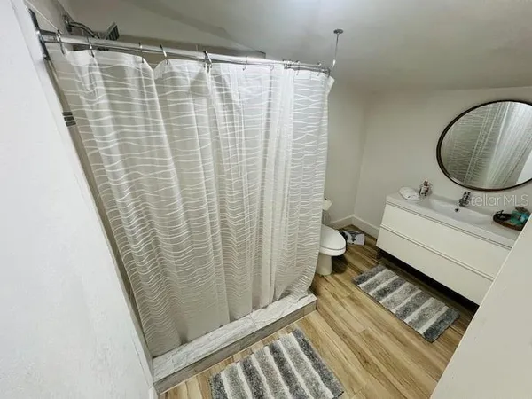 a bathroom with a sink toilet and shower