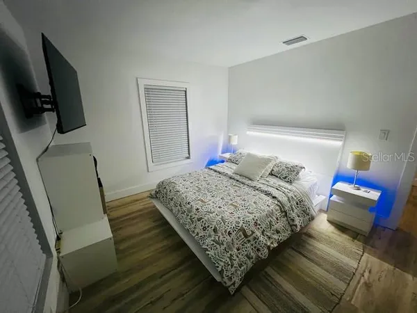 a bedroom with bed and mirror