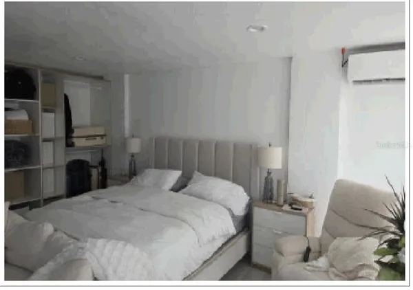 a bedroom with a bed and a television